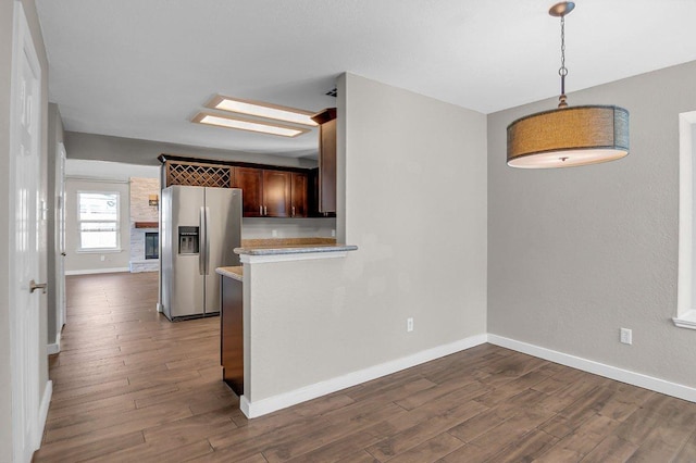 15811 De Peer Cv, Austin, TX 78717 - kitchen with stainless steel refrigerator with ice dispenser, light countertops, dark wood-style floors, and decorative light fixtures