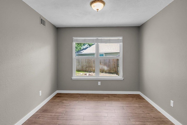 15811 De Peer Cv, Austin, TX 78717 - unfurnished room featuring wood finished floors and a textured wall