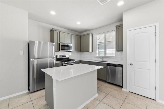252 Fabion St, Kyle, TX 78640 - kitchen with stainless steel appliances, gray cabinetry, a sink, decorative backsplash, and recessed lighting