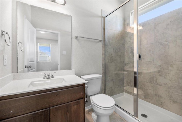 252 Fabion St, Kyle, TX 78640 - bathroom with vanity, a stall shower, and toilet