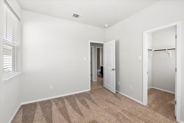 252 Fabion St, Kyle, TX 78640 - unfurnished bedroom featuring carpet floors, baseboards, a spacious closet, and a closet