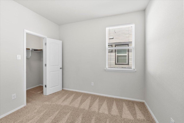 252 Fabion St, Kyle, TX 78640 - unfurnished bedroom with carpet, baseboards, a spacious closet, and a closet
