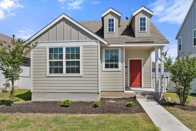 252 Fabion St, Kyle, TX 78640 - view of front facade with board and batten siding, roof with shingles, and a front lawn