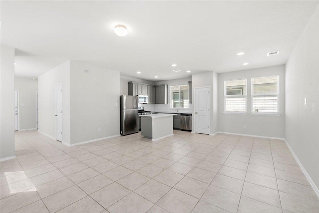 252 Fabion St, Kyle, TX 78640 - unfurnished living room featuring light tile patterned flooring, baseboards, and recessed lighting