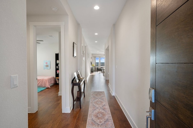 344 Pisa Ln, Georgetown, TX 78628 - hallway featuring dark wood-style floors, baseboards, and recessed lighting