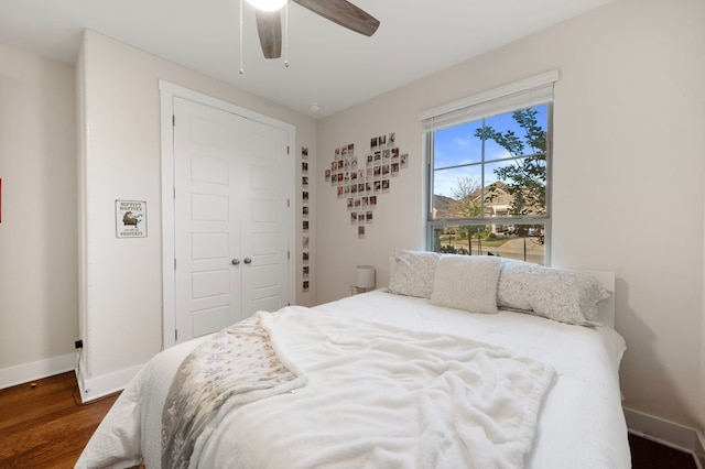 344 Pisa Ln, Georgetown, TX 78628 - bedroom with dark wood finished floors, baseboards, a closet, and ceiling fan