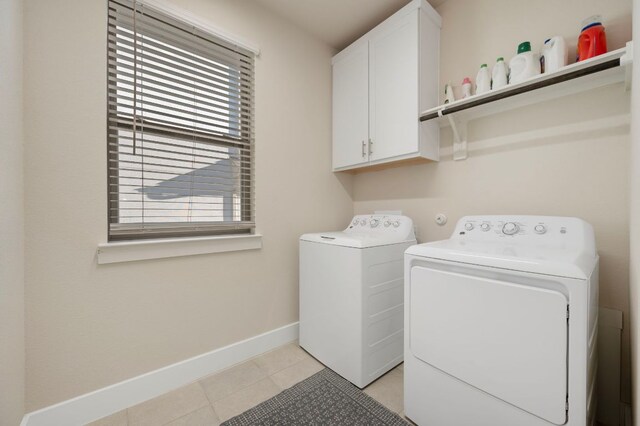 344 Pisa Ln, Georgetown, TX 78628 - laundry room featuring washing machine and clothes dryer, cabinet space, baseboards, and light tile patterned floors