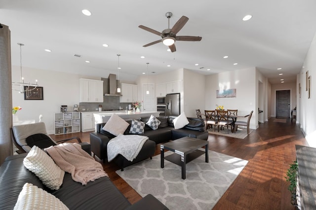 344 Pisa Ln, Georgetown, TX 78628 - living room with a ceiling fan, dark wood finished floors, recessed lighting, baseboards, and a chandelier