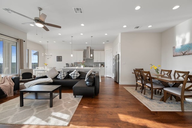 344 Pisa Ln, Georgetown, TX 78628 - living area featuring dark wood-type flooring, a ceiling fan, recessed lighting, a chandelier, and baseboards