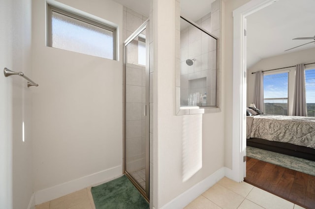 344 Pisa Ln, Georgetown, TX 78628 - ensuite bathroom featuring a shower stall, tile patterned flooring, ceiling fan, baseboards, and lofted ceiling