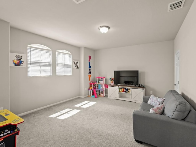 recreation room with carpet floors, baseboards, and visible vents