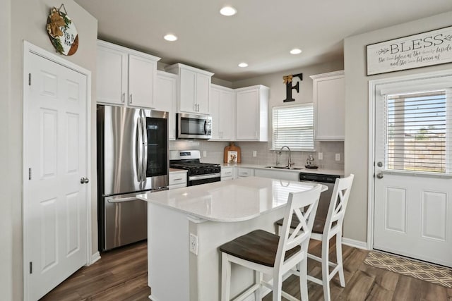 121 Audie Murphy Dr, Leander, TX 78641 - kitchen featuring stainless steel appliances, a sink, white cabinets, tasteful backsplash, and recessed lighting