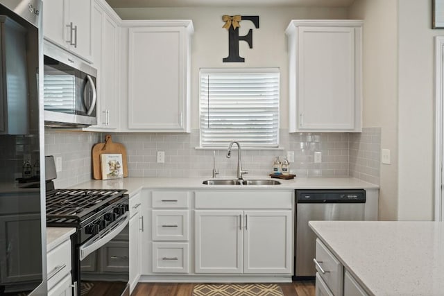 kitchen featuring a sink, white cabinetry, and stainless steel appliances