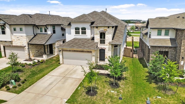 view of front facade featuring fence, an attached garage, stone siding, stucco siding, and driveway