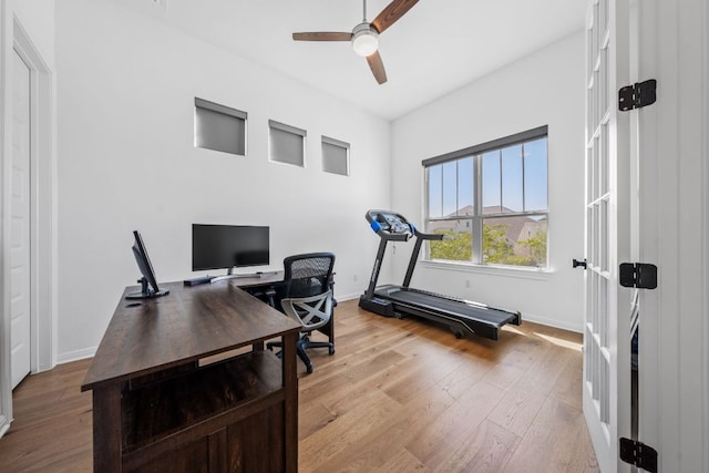 office space with ceiling fan, wood finished floors, and baseboards