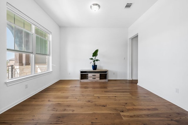 empty room with wood finished floors and baseboards