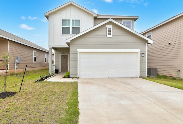 traditional-style house with board and batten siding, a garage, central air condition unit, a front yard, and concrete driveway