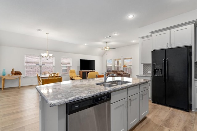 728 Clear Spring Ln, Leander, TX 78641 - kitchen featuring black refrigerator with ice dispenser, dishwasher, light wood-style flooring, a kitchen island with sink, and a ceiling fan
