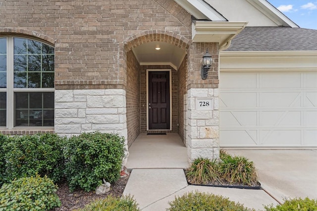 728 Clear Spring Ln, Leander, TX 78641 - property entrance with an attached garage, stone siding, roof with shingles, and brick siding