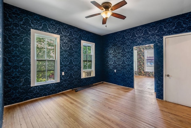 523 Ash St, Lockhart, TX 78644 - unfurnished room featuring wallpapered walls, hardwood / wood-style floors, and ceiling fan