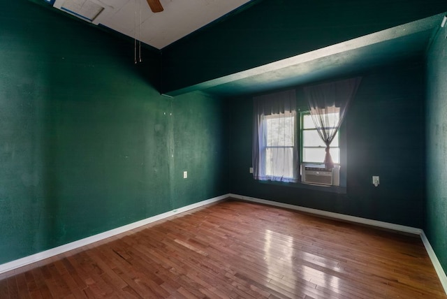 523 Ash St, Lockhart, TX 78644 - empty room with baseboards, vaulted ceiling, cooling unit, ceiling fan, and wood finished floors
