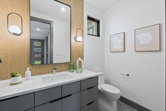 5908 Lakeside Trl, Austin, TX 78734 - bathroom with vanity, toilet, tile patterned floors, and baseboards