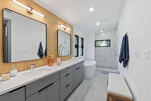 5908 Lakeside Trl, Austin, TX 78734 - bathroom featuring a shower stall, double vanity, a freestanding tub, vaulted ceiling, and wooden walls
