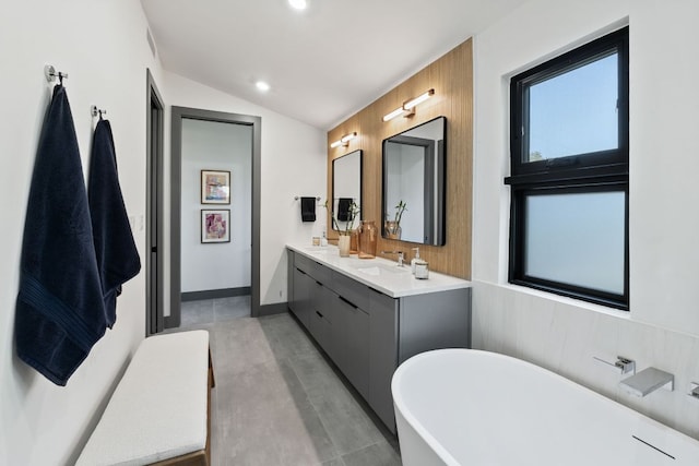 5908 Lakeside Trl, Austin, TX 78734 - full bath with a freestanding bath, double vanity, recessed lighting, concrete floors, and lofted ceiling