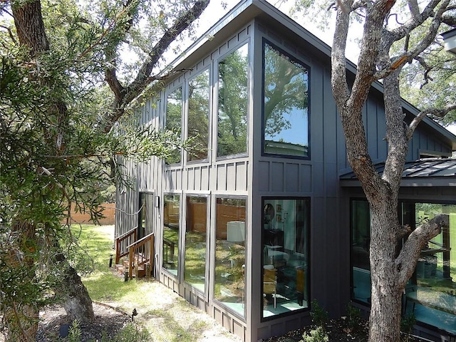 5908 Lakeside Trl, Austin, TX 78734 - view of home's exterior with a sunroom and board and batten siding