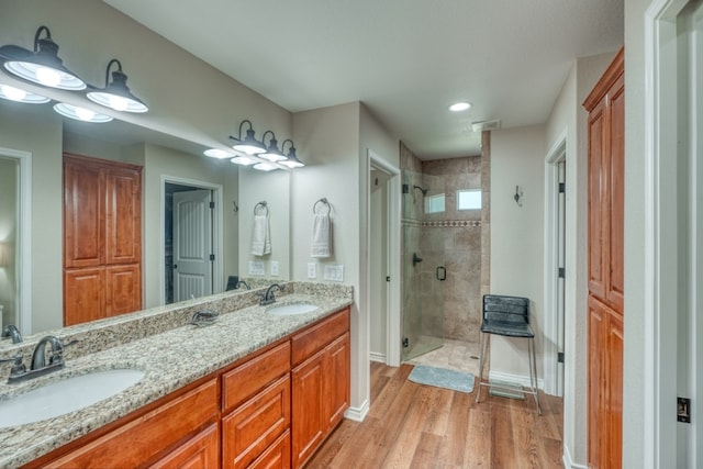 103 Ladera Cv, Marble Falls, TX 78654 - full bath with a stall shower, double vanity, wood finished floors, baseboards, and recessed lighting