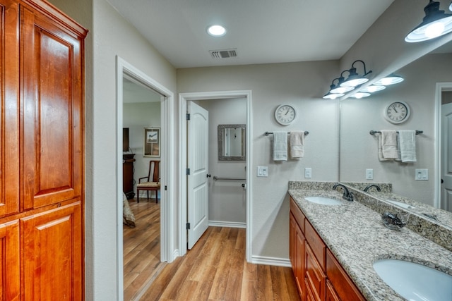 103 Ladera Cv, Marble Falls, TX 78654 - full bathroom featuring wood finished floors, double vanity, and baseboards