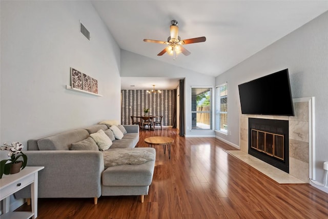14585 Robert I Walker Blvd, Austin, TX 78728 - living area with lofted ceiling, ceiling fan, a tiled fireplace, wood finished floors, and a chandelier