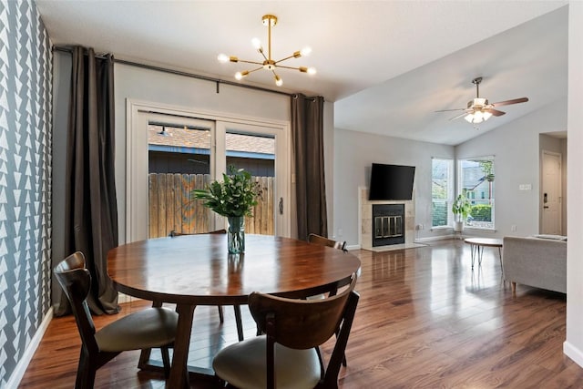 14585 Robert I Walker Blvd, Austin, TX 78728 - dining area with wood finished floors, a chandelier, a tile fireplace, vaulted ceiling, and ceiling fan