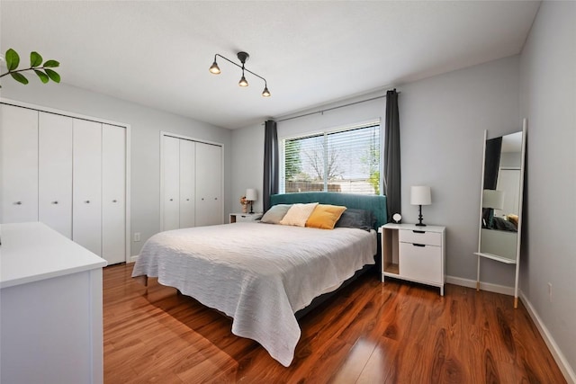 14585 Robert I Walker Blvd, Austin, TX 78728 - bedroom featuring multiple closets, wood finished floors, and baseboards
