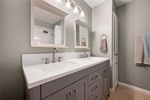 14585 Robert I Walker Blvd, Austin, TX 78728 - bathroom with double vanity, tile patterned flooring, and baseboards