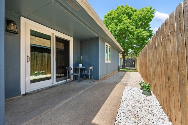 14585 Robert I Walker Blvd, Austin, TX 78728 - view of side of property with a patio, board and batten siding, and a fenced backyard