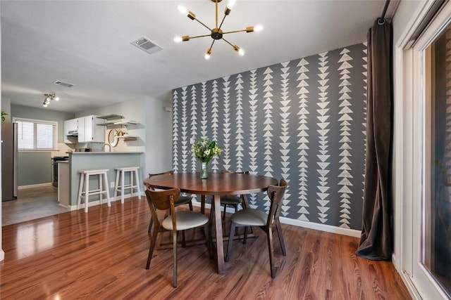 14585 Robert I Walker Blvd, Austin, TX 78728 - dining room featuring wood finished floors, a chandelier, and baseboards