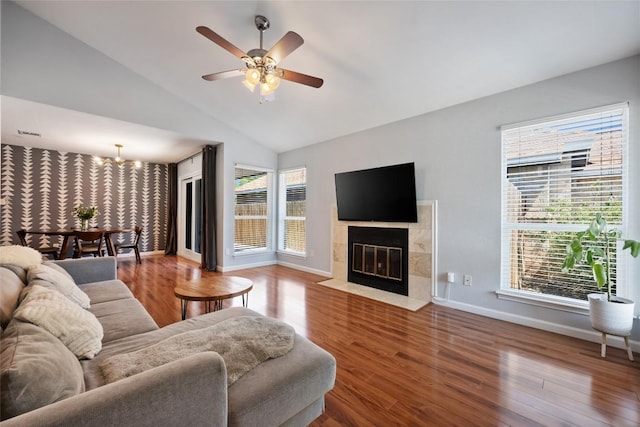 14585 Robert I Walker Blvd, Austin, TX 78728 - living area featuring a chandelier, a ceiling fan, wood finished floors, vaulted ceiling, and baseboards