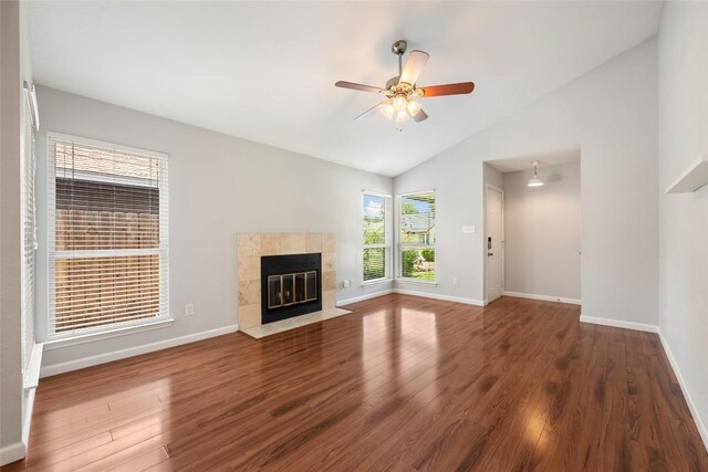 14585 Robert I Walker Blvd, Austin, TX 78728 - unfurnished living room featuring lofted ceiling, wood finished floors, a tile fireplace, and a ceiling fan