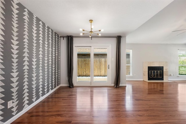 14585 Robert I Walker Blvd, Austin, TX 78728 - unfurnished living room with a chandelier, wood finished floors, and a fireplace