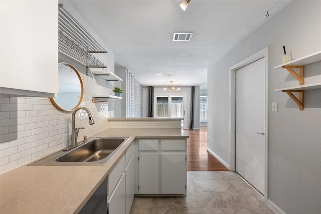 14585 Robert I Walker Blvd, Austin, TX 78728 - kitchen featuring open shelves, a peninsula, tasteful backsplash, and light countertops