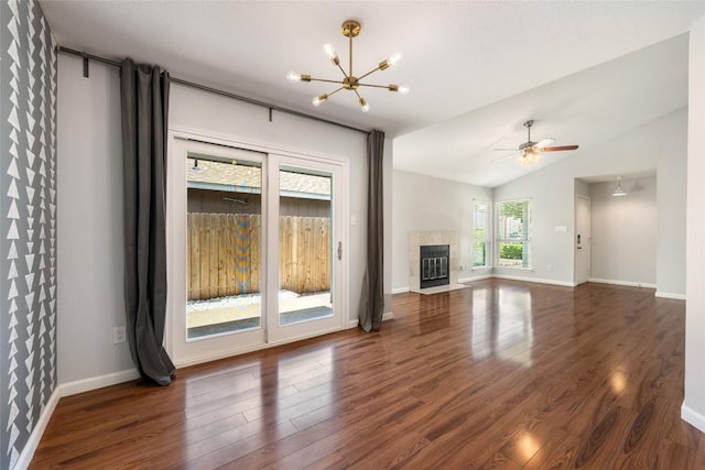 14585 Robert I Walker Blvd, Austin, TX 78728 - unfurnished living room with dark wood-style floors, a chandelier, vaulted ceiling, a tile fireplace, and a ceiling fan