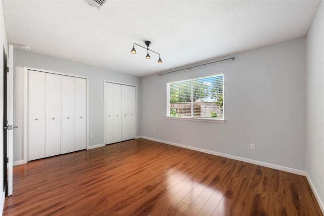 14585 Robert I Walker Blvd, Austin, TX 78728 - unfurnished bedroom featuring multiple closets and wood finished floors