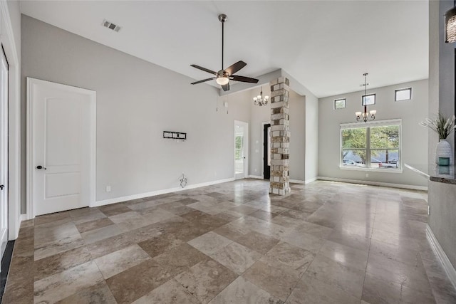 21434 Lakefront Dr, Lago Vista, TX 78645 - unfurnished living room with a chandelier, a ceiling fan, baseboards, and a high ceiling