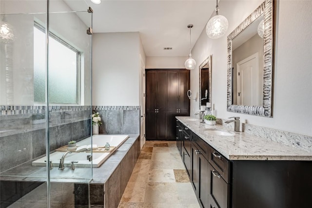 21434 Lakefront Dr, Lago Vista, TX 78645 - bathroom with a bath, double vanity, stone finish floors, and an enclosed shower