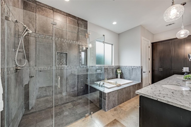 21434 Lakefront Dr, Lago Vista, TX 78645 - bathroom with a garden tub, vanity, a stall shower, and recessed lighting