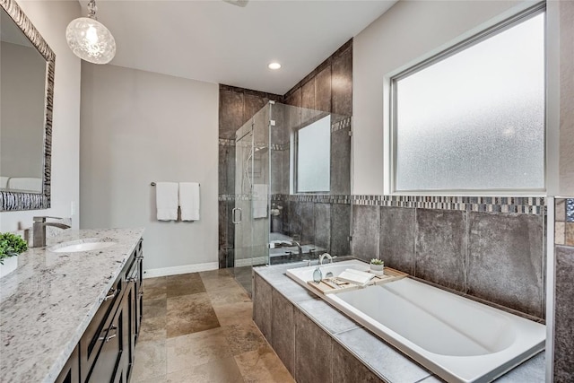 21434 Lakefront Dr, Lago Vista, TX 78645 - full bathroom with vanity, a shower stall, a garden tub, recessed lighting, and baseboards