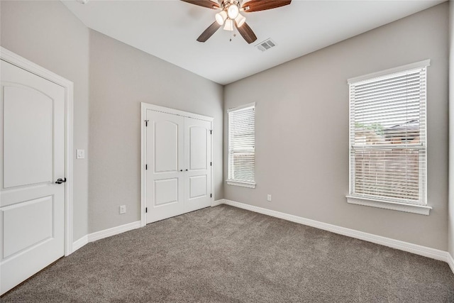21434 Lakefront Dr, Lago Vista, TX 78645 - unfurnished bedroom featuring carpet flooring, a closet, and a ceiling fan