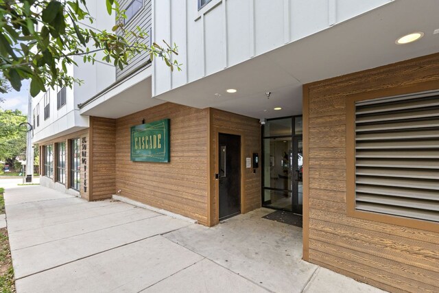 2500 Longview St Unit 418, Austin, TX 78705 - view of exterior entry with board and batten siding and a patio area