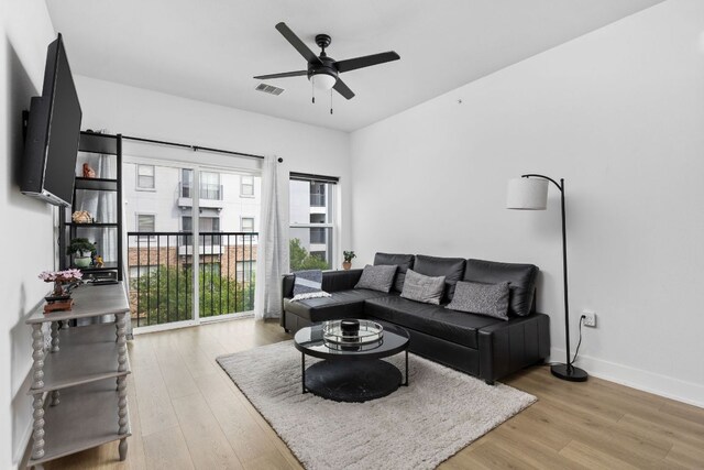 2500 Longview St Unit 418, Austin, TX 78705 - living area with a ceiling fan, light wood-style floors, and baseboards